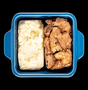 Mashed potatoes and roast beef in a blue dish