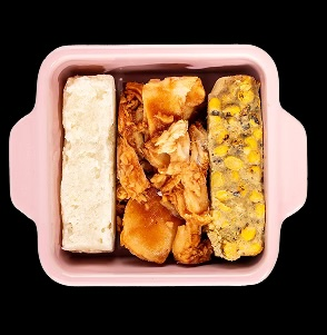 Three-part frozen meal in a pink dish